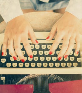 Woman Typing On A Typewriter